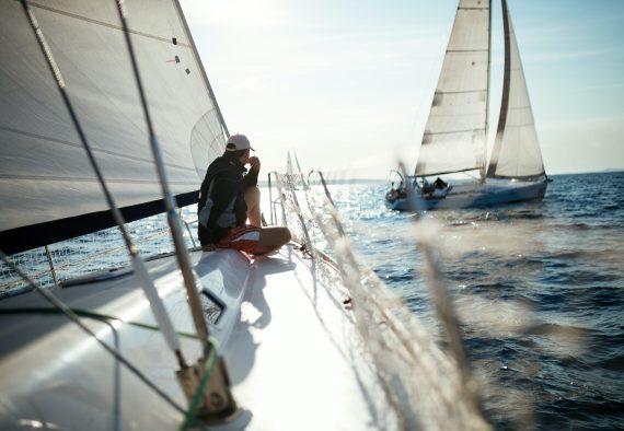 Young handsome man relaxing on his sailboat